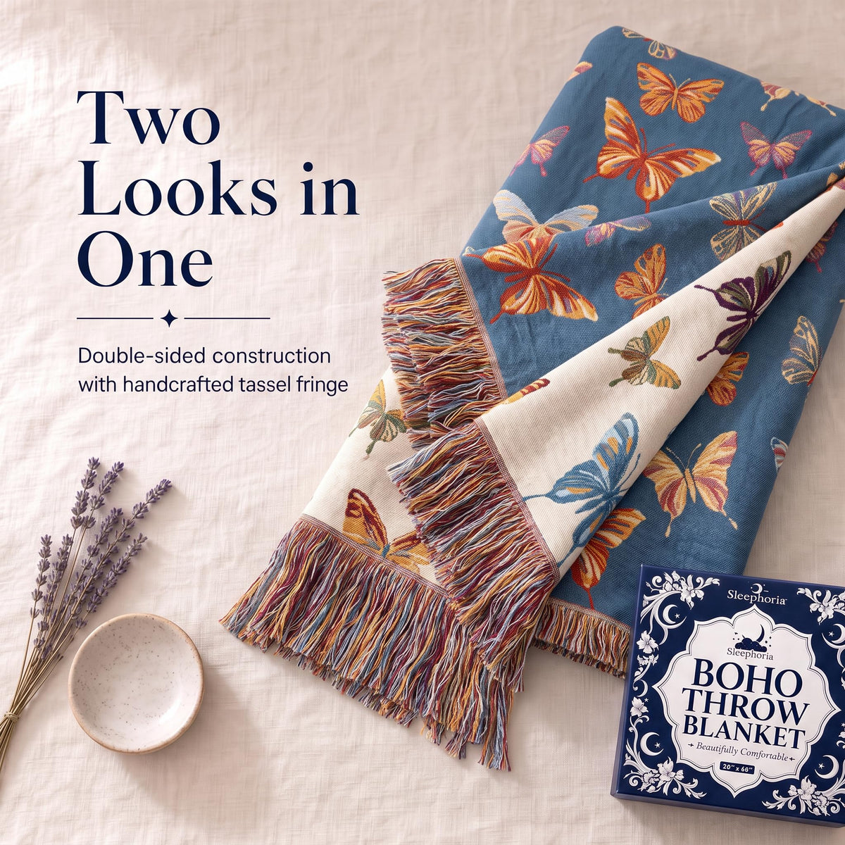 Folded corner of a blue butterfly patterned throw showing its contrasting reverse and fringe beneath "Two Looks in One".