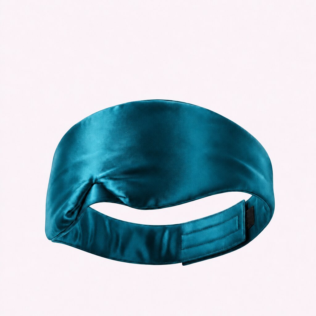 Teal wide sleep mask viewed from behind, showing its adjustable fastening strap on a pale background.