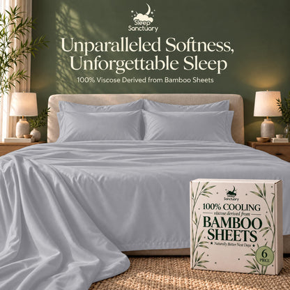 Silver gray sheets and matching pillows on a bed beside a sheet box, beneath the words "Unparalleled Softness, Unforgettable Sleep".