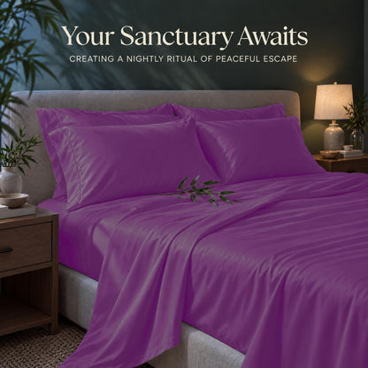 Purple sheets and matching pillows on a bed beside a lamp, beneath the heading "Your Sanctuary Awaits".