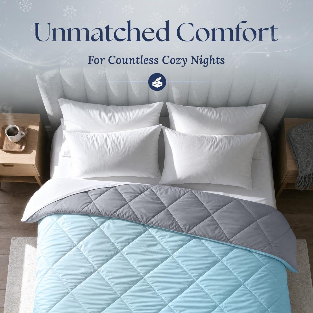 Overhead view of a light blue diamond quilted comforter folded back to show its gray reverse, with four white pillows.
