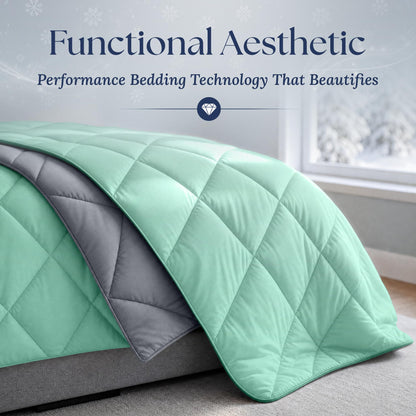 Close view of a mint green diamond quilted comforter draped over a bed, showing its gray reverse and piped edge.