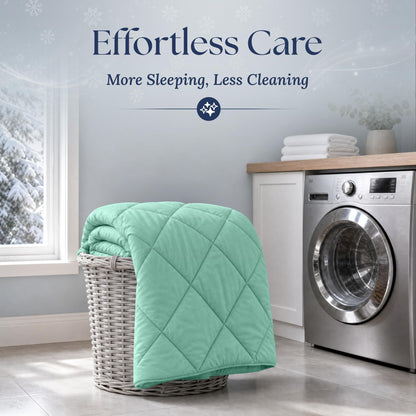 Mint green quilted comforter draped over a wicker laundry basket beside a washing machine. Graphic reads "Effortless Care".