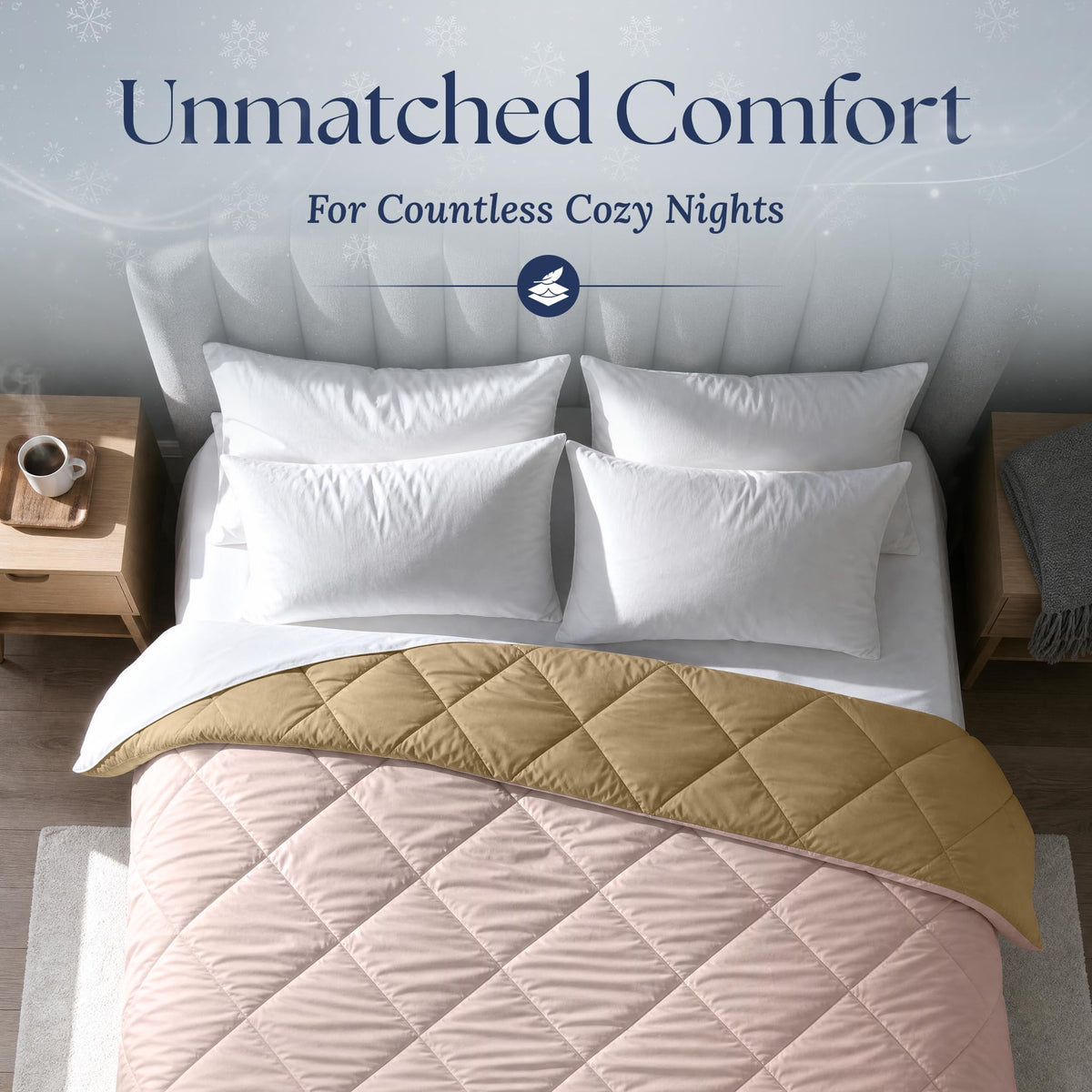 Overhead view of a blush pink diamond quilted comforter folded back to show its tan reverse, with four white pillows.