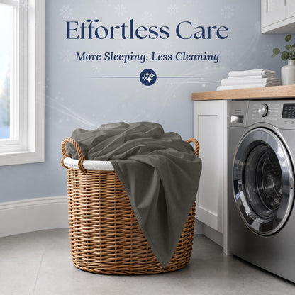 Warm gray fitted sheet draped over a wicker laundry basket beside a washing machine. Graphic reads "Effortless Care".