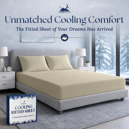 Cream fitted sheet pulled over a mattress with two matching pillows on a gray bed, beside Sleephoria packaging.