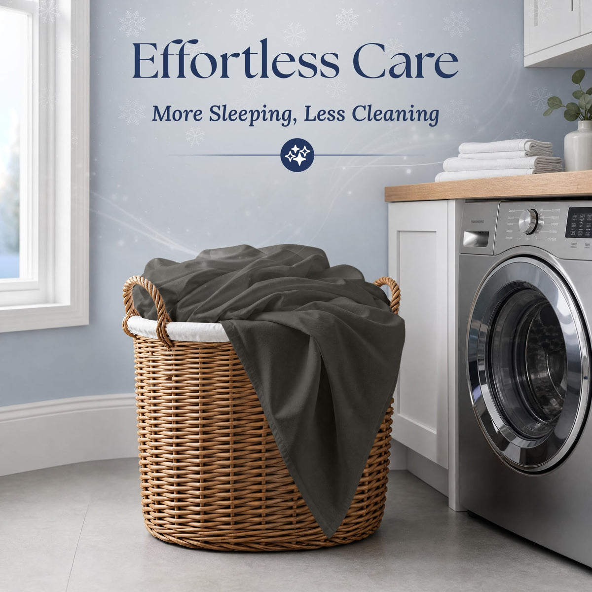 Charcoal gray fitted sheet draped over a wicker laundry basket beside a washing machine. Graphic reads "Effortless Care".