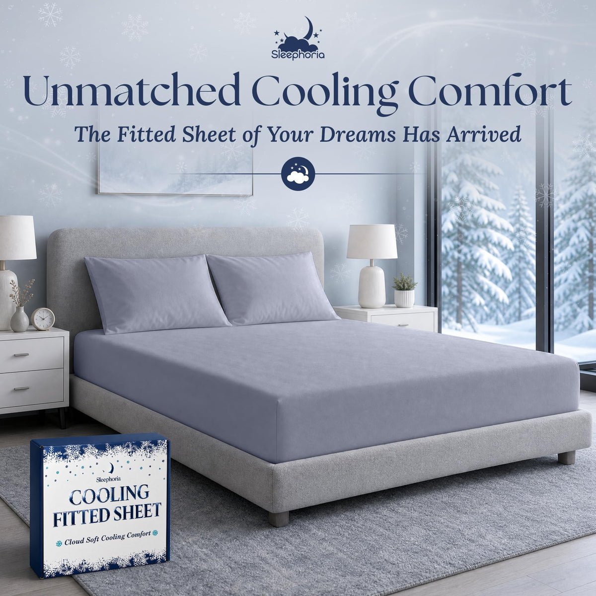 Pale blue gray fitted sheet pulled over a mattress with two matching pillows on a gray bed, beside Sleephoria packaging.