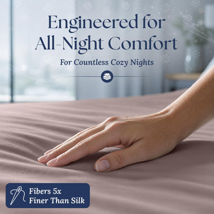 A hand smoothing a blush pink fitted sheet. The graphic reads "Fibers 5x Finer Than Silk".