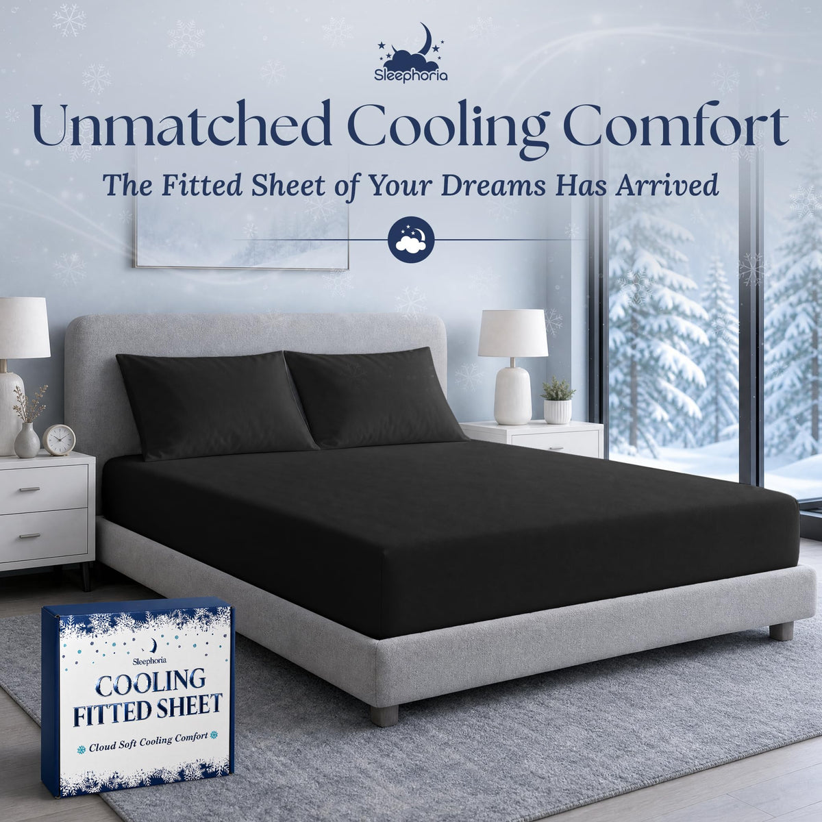 Black fitted sheet pulled over a mattress with two matching pillows on a gray bed, beside Sleephoria packaging.