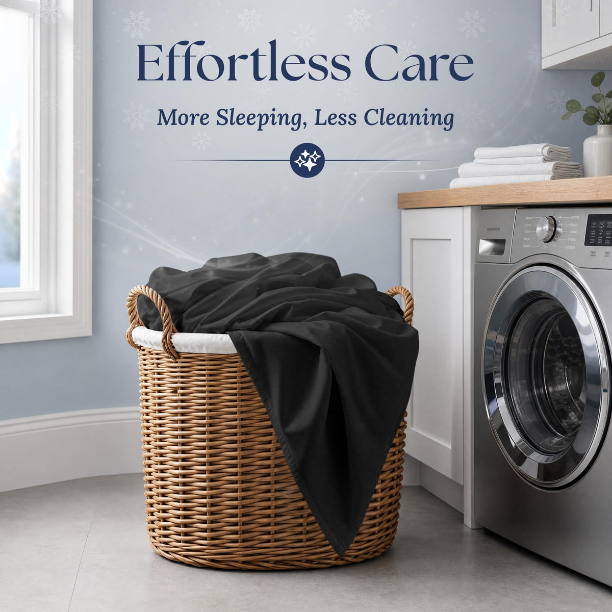 Black fitted sheet draped over a wicker laundry basket beside a washing machine. Graphic reads "Effortless Care".