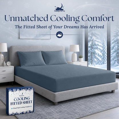 Navy blue fitted sheet pulled over a mattress with two matching pillows on a gray bed, beside Sleephoria packaging.