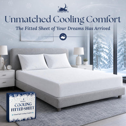 White fitted sheet pulled over a mattress with two matching pillows on a gray bed, beside Sleephoria packaging.