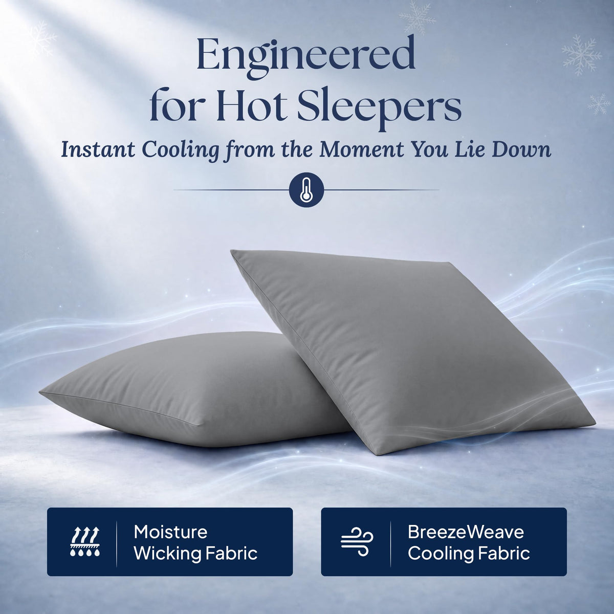 Two dark gray pillows with illustrated airflow. Graphic labels: moisture wicking fabric and BreezeWeave cooling fabric.