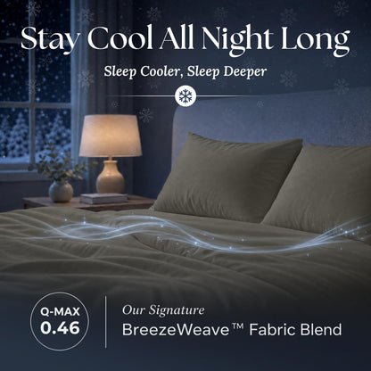 Dark gray sheets and matching pillows on a bed at night with flowing light effects and BreezeWeave and Q-MAX 0.46 labels.