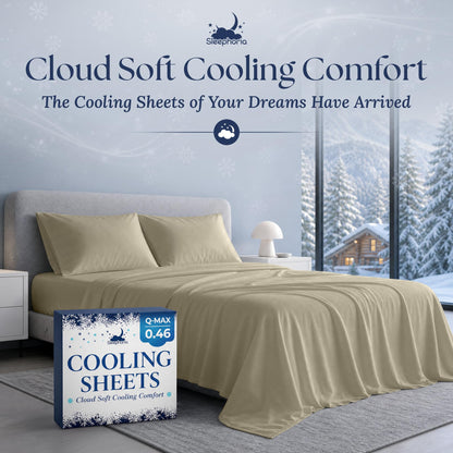 Cream sheets and two matching pillows on a gray bed beside Sleephoria Cooling Sheets packaging, with snowy trees outside.