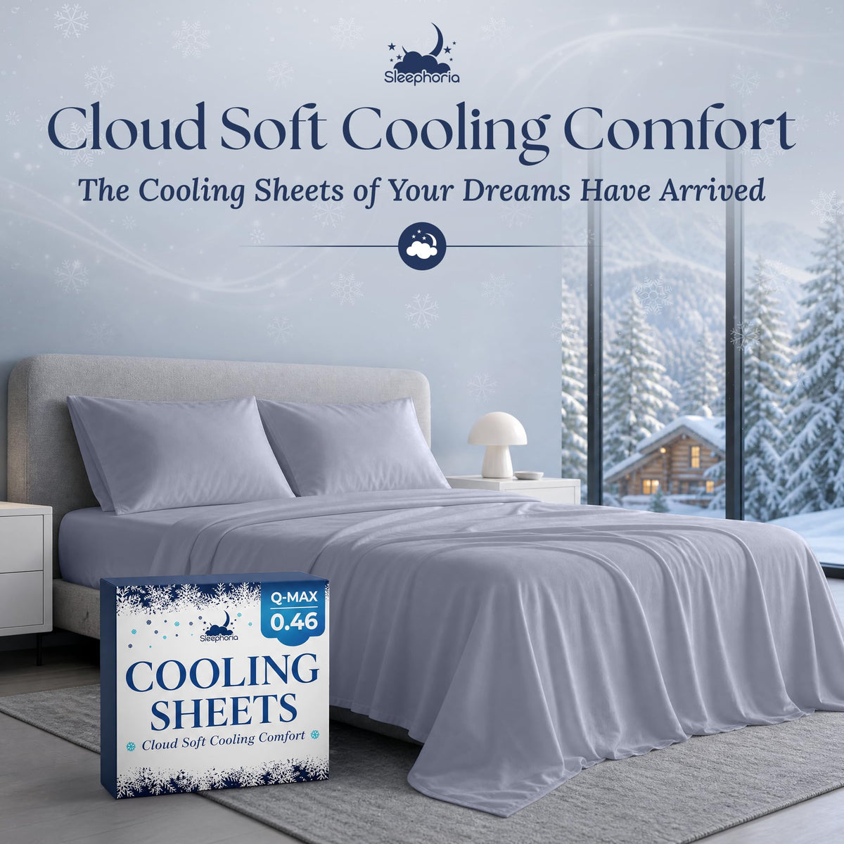 Pale blue gray sheets and two matching pillows on a gray bed beside Sleephoria Cooling Sheets packaging, with snowy trees outside.