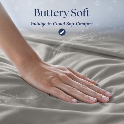 A hand smoothing light gray fabric with a soft sheen. Graphic reads "Buttery Soft".