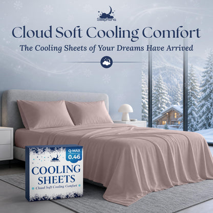 Blush pink sheets and two matching pillows on a gray bed beside Sleephoria Cooling Sheets packaging, with snowy trees outside.