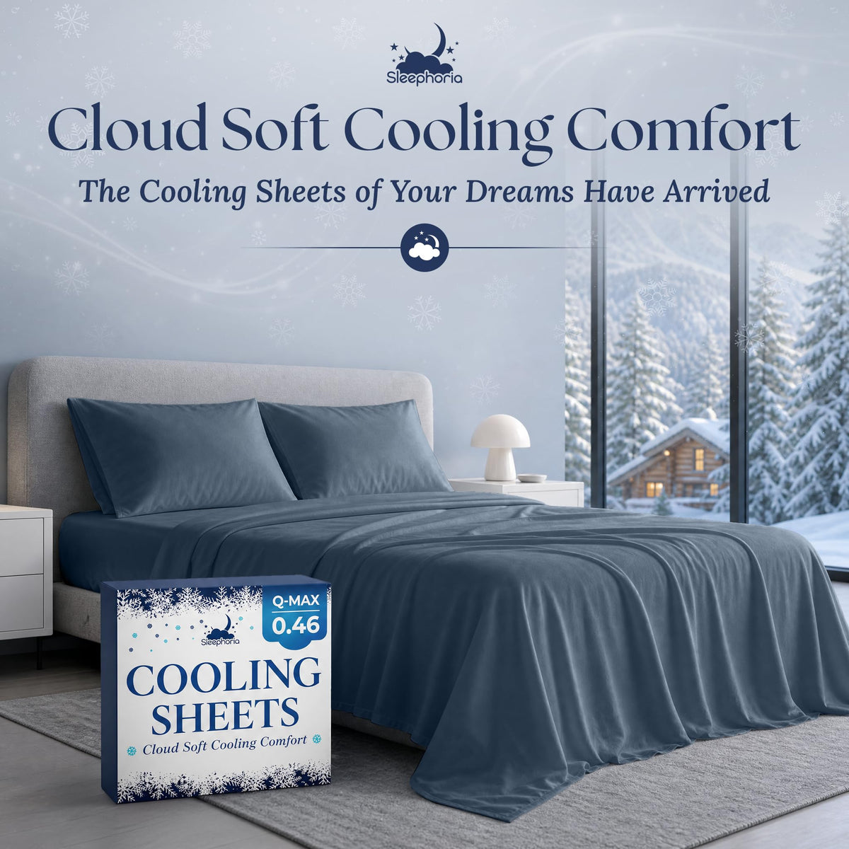 Navy blue sheets and two matching pillows on a gray bed beside Sleephoria Cooling Sheets packaging, with snowy trees outside.