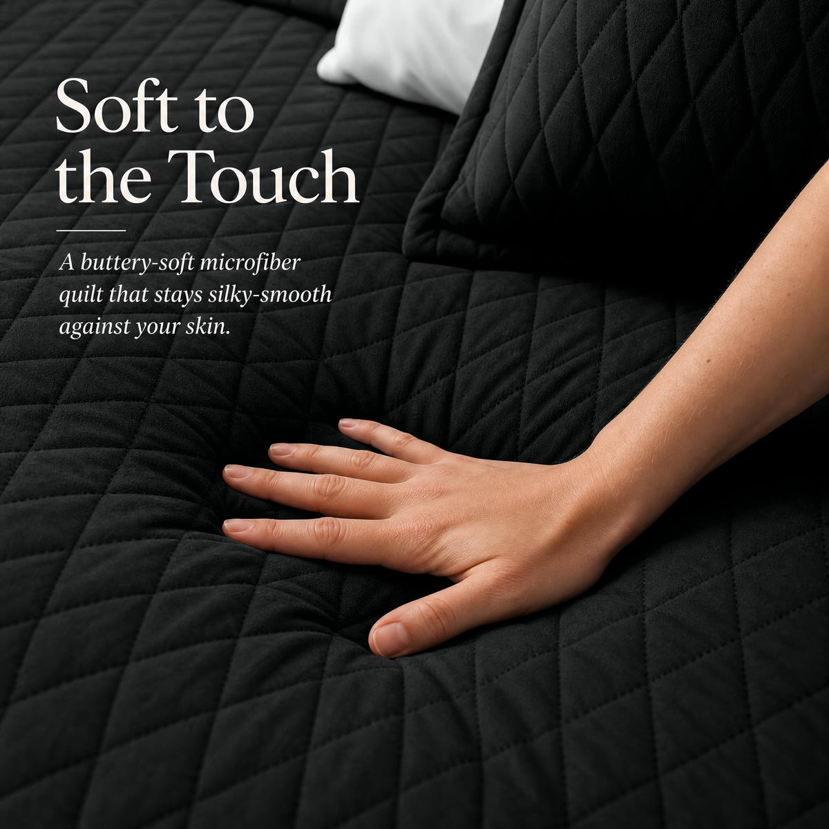 Hand touching a black diamond stitched quilt beside matching shams beneath "Soft to the Touch".