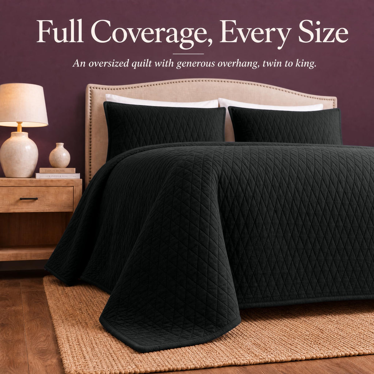 Black diamond quilt draped over both sides and the foot of a bed with matching shams beneath "Full Coverage, Every Size".