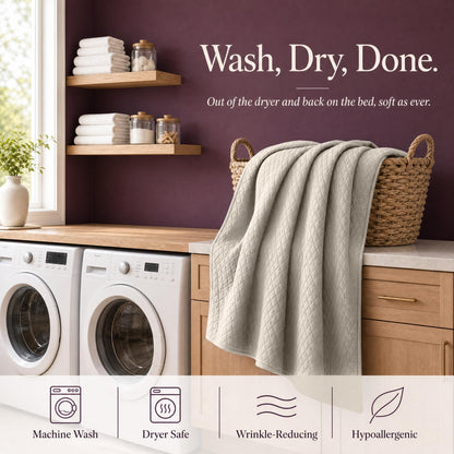Ivory quilt draped over a wicker basket above laundry machines beneath "Wash, Dry, Done".