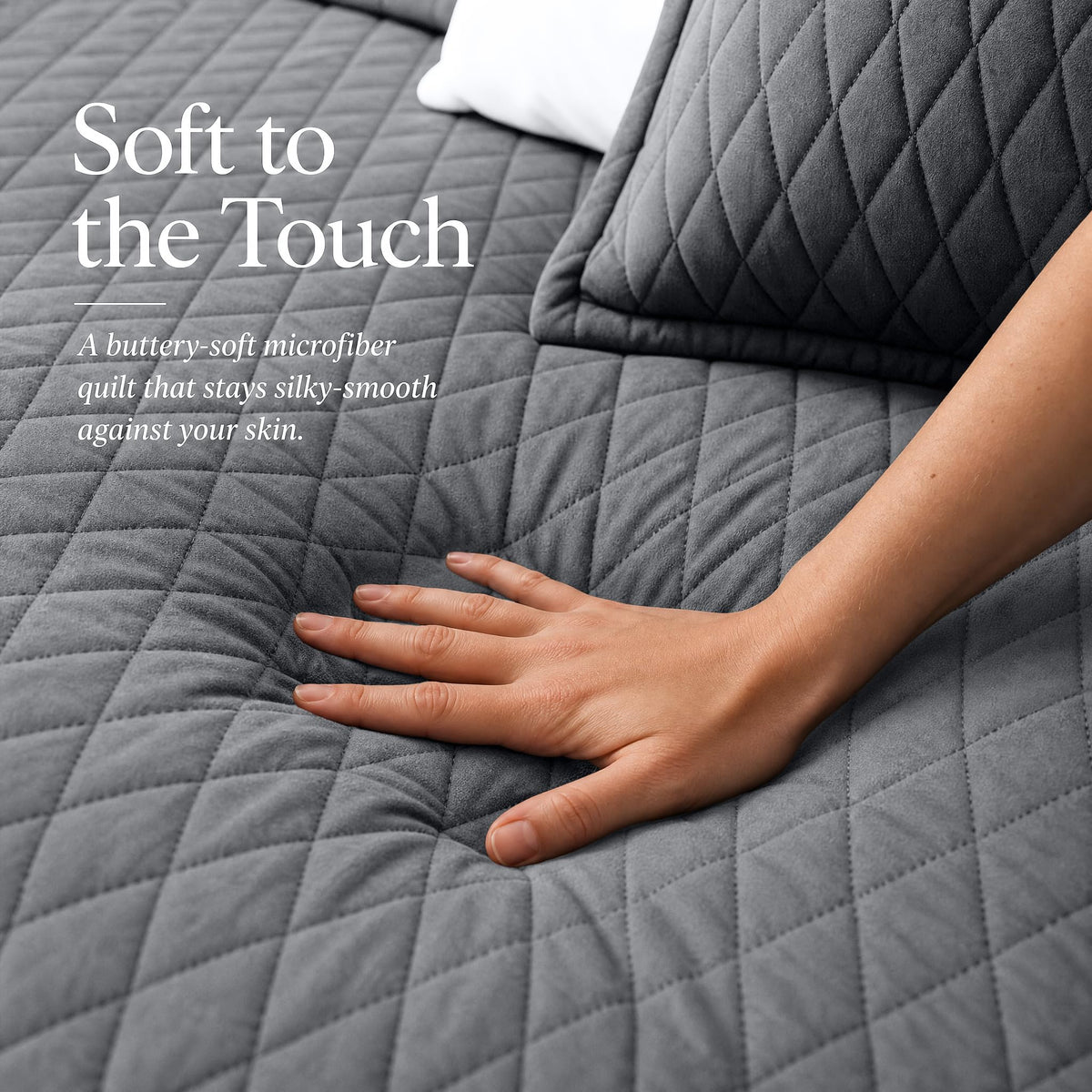Hand touching a gray diamond stitched quilt beside matching shams beneath "Soft to the Touch".