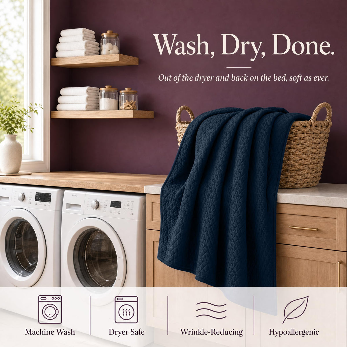 Navy blue quilt draped over a wicker basket above laundry machines beneath "Wash, Dry, Done".