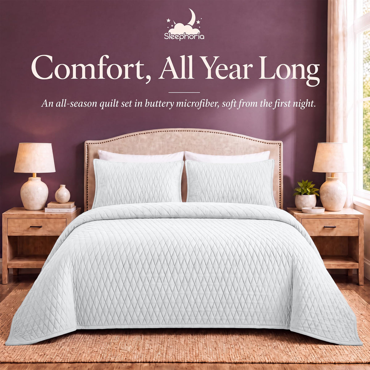 White diamond quilt and matching shams on a bed between wooden nightstands beneath "Comfort, All Year Long".