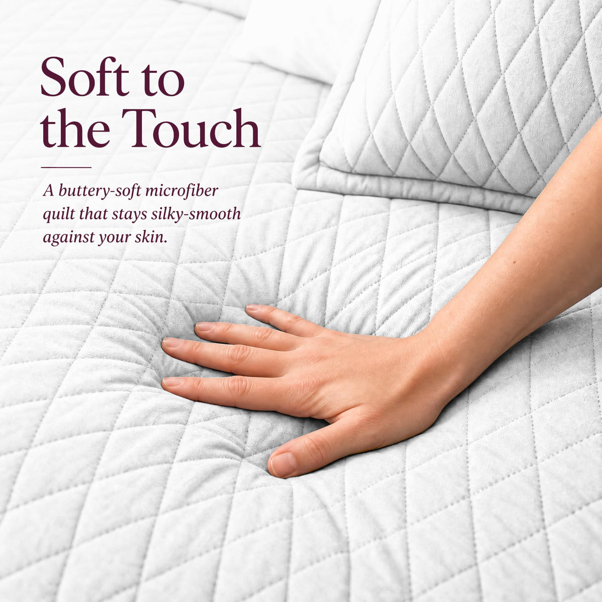 Hand touching a white diamond stitched quilt beside matching shams beneath "Soft to the Touch".