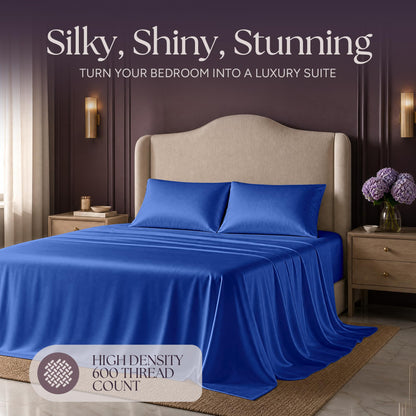 Royal blue satin bedding on an upholstered bed beneath "Silky, Shiny, Stunning", with a printed 600 thread count label.