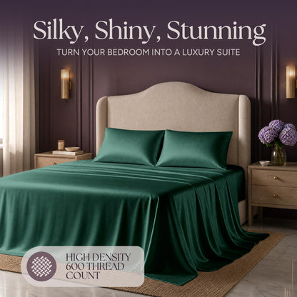 Emerald green satin bedding on an upholstered bed beneath "Silky, Shiny, Stunning", with a printed 600 thread count label.
