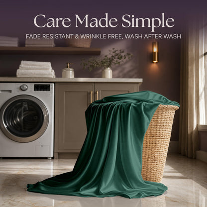 Emerald green satin fabric draped over a wicker laundry basket beside a washing machine beneath "Care Made Simple".