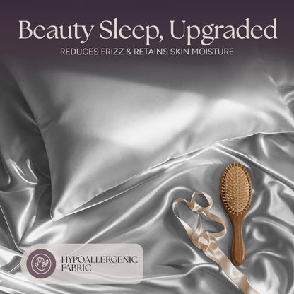 Silver gray satin pillow and rumpled fabric with a wooden hairbrush and ribbon beneath "Beauty Sleep, Upgraded".