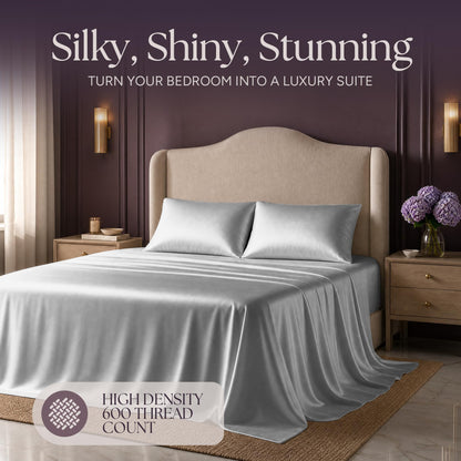 Silver gray satin bedding on an upholstered bed beneath "Silky, Shiny, Stunning", with a printed 600 thread count label.