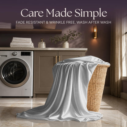 Silver gray satin fabric draped over a wicker laundry basket beside a washing machine beneath "Care Made Simple".
