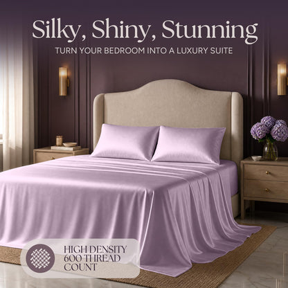 Lavender satin bedding on an upholstered bed beneath "Silky, Shiny, Stunning", with a printed 600 thread count label.