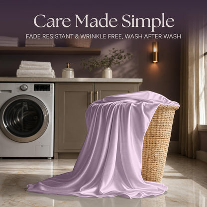 Lavender satin fabric draped over a wicker laundry basket beside a washing machine beneath "Care Made Simple".
