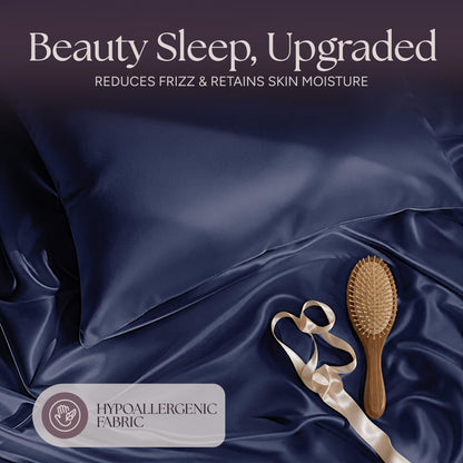 Navy blue satin pillow and rumpled fabric with a wooden hairbrush and ribbon beneath "Beauty Sleep, Upgraded".