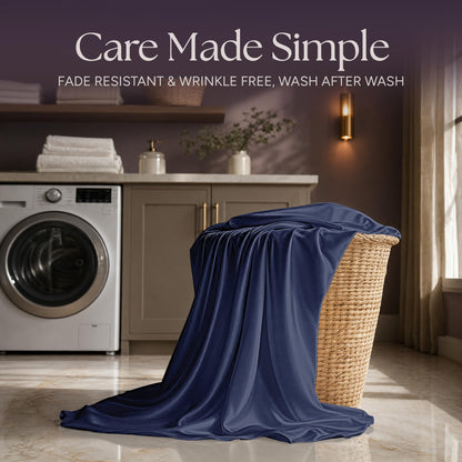 Navy blue satin fabric draped over a wicker laundry basket beside a washing machine beneath "Care Made Simple".