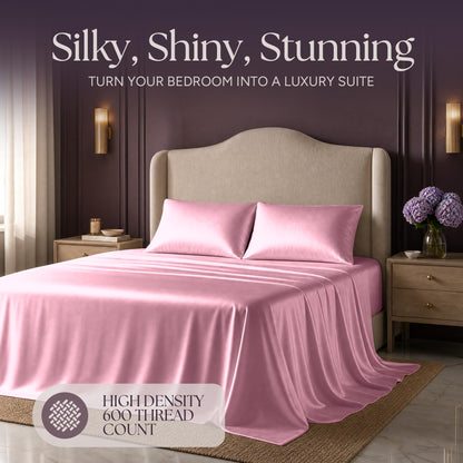 Pink satin bedding on an upholstered bed beneath "Silky, Shiny, Stunning", with a printed 600 thread count label.