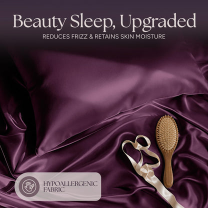 Plum satin pillow and rumpled fabric with a wooden hairbrush and ribbon beneath "Beauty Sleep, Upgraded".