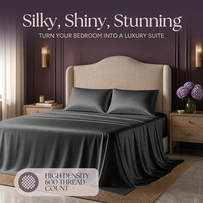 Dark gray satin bedding on an upholstered bed beneath "Silky, Shiny, Stunning", with a printed 600 thread count label.