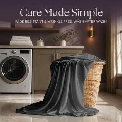 Dark gray satin fabric draped over a wicker laundry basket beside a washing machine beneath "Care Made Simple".