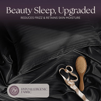 Black striped satin pillow and rumpled fabric with a wooden hairbrush and ribbon beneath "Beauty Sleep, Upgraded".
