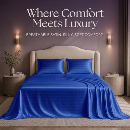 Royal blue striped satin sheets and two matching pillows on a bed beneath "Where Comfort Meets Luxury".