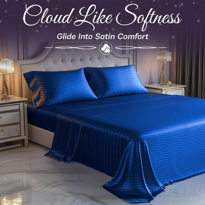 Royal blue striped satin sheets and pillows on a tufted bed between mirrored nightstands, beneath "Cloud Like Softness".
