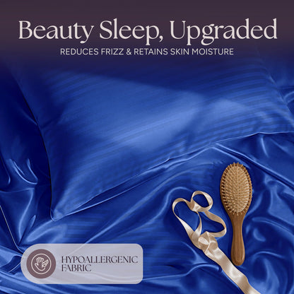 Royal blue striped satin pillow and rumpled fabric with a wooden hairbrush and ribbon beneath "Beauty Sleep, Upgraded".