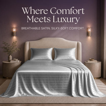 Silver gray striped satin sheets and two matching pillows on a bed beneath "Where Comfort Meets Luxury".